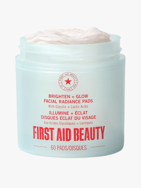 First Aid Beauty Brighten + Glow Facial Radiance Pads in branded tub component on a light gray background
