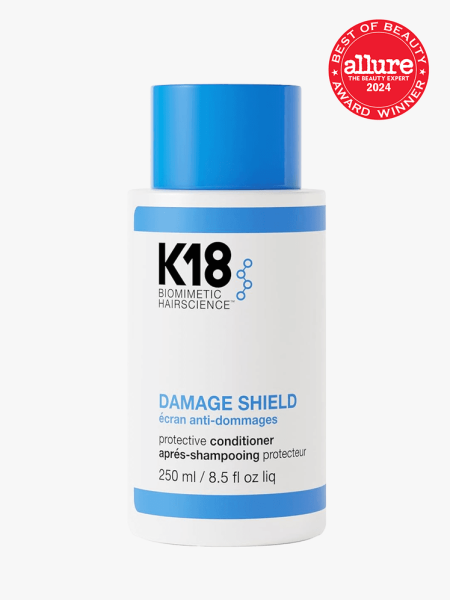 K18 Damage Shield Conditioner in branded bottle component with best of beauty seal in the top right corner on a light gray background
